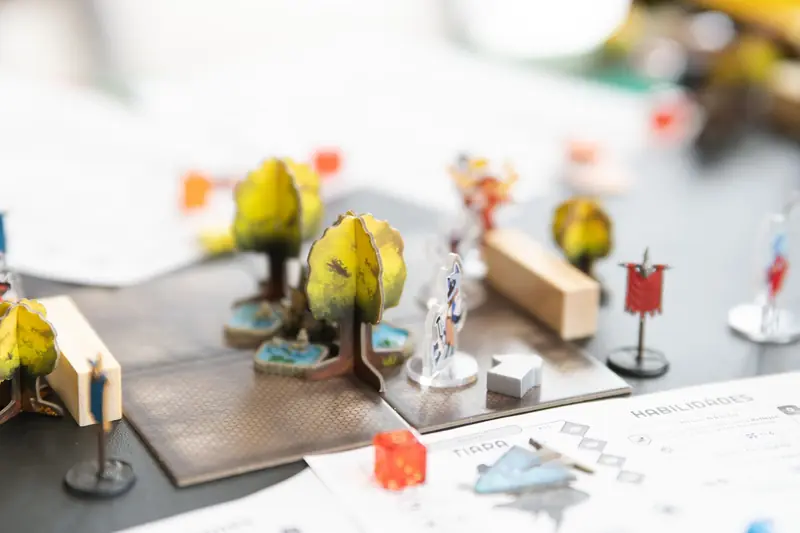 Detailed setup of a tabletop role-playing game with miniature figures and dice in San José, Costa Rica